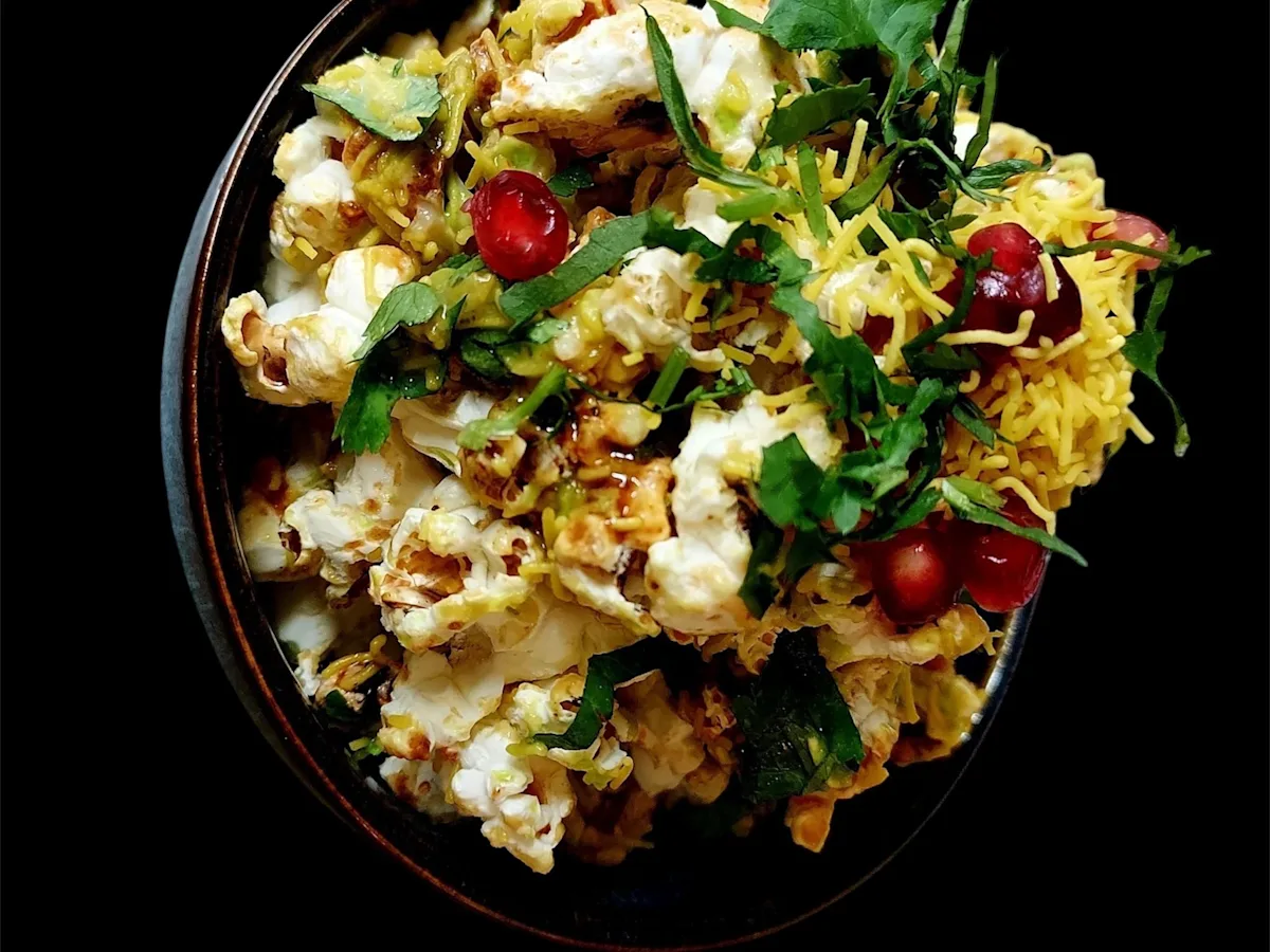 Popcorn chaat with sev, coriander and pomegranate